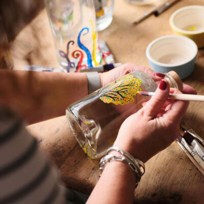 Beautifully painted design on a premium gin bottle, showcasing artistry and unique branding – Say it with Gin.