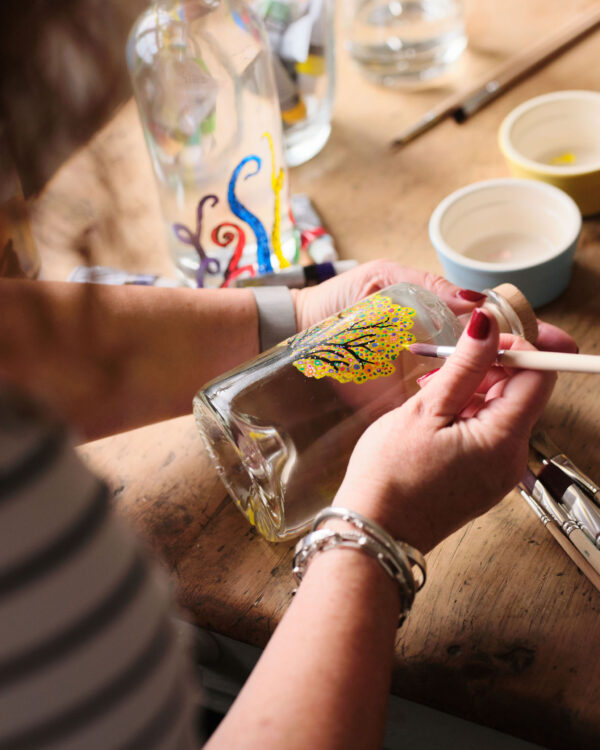 Beautifully painted design on a premium gin bottle, showcasing artistry and unique branding – Say it with Gin.